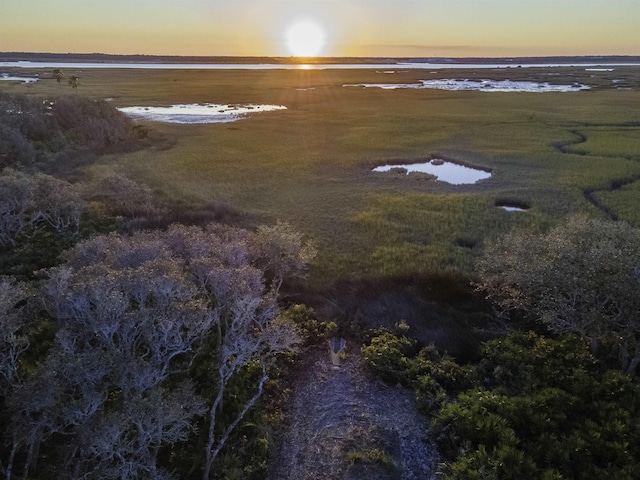 aerial view at dusk featuring a water view