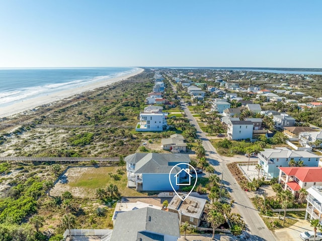 birds eye view of property with a view of the beach and a water view