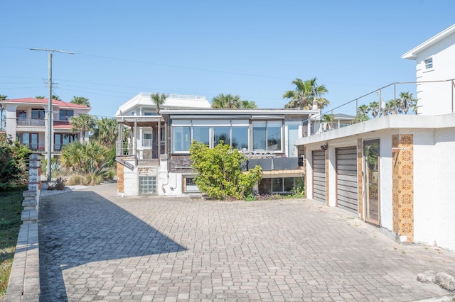 view of front of house with decorative driveway and a garage