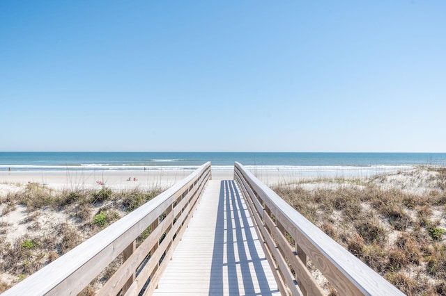 surrounding community featuring a view of the beach and a water view