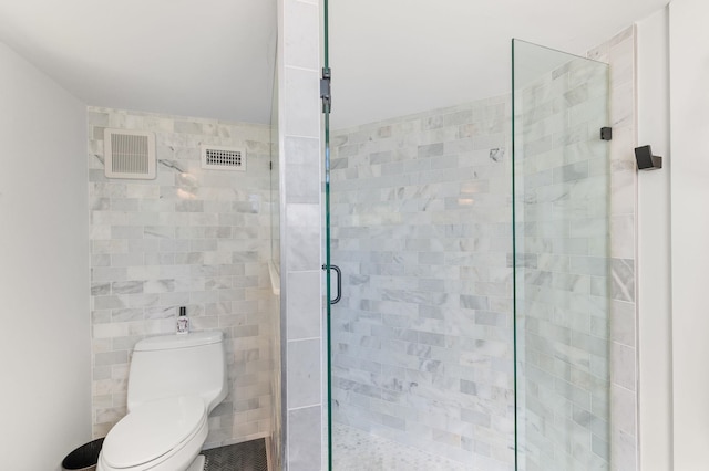 bathroom with visible vents, a stall shower, and toilet