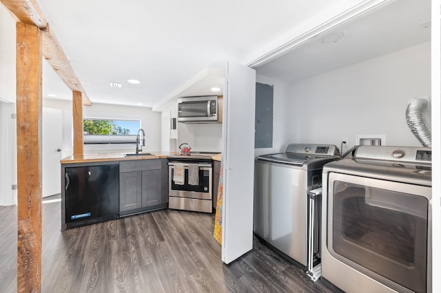 laundry area with washing machine and dryer, electric panel, recessed lighting, dark wood-style floors, and a sink