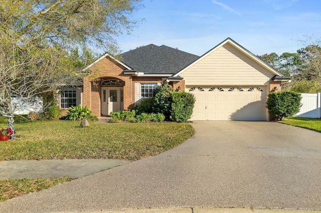 ranch-style house with a garage, brick siding, a shingled roof, concrete driveway, and a front lawn