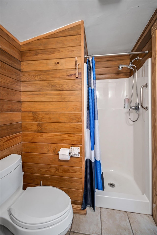 bathroom featuring tile patterned floors, a shower with curtain, wood walls, and toilet