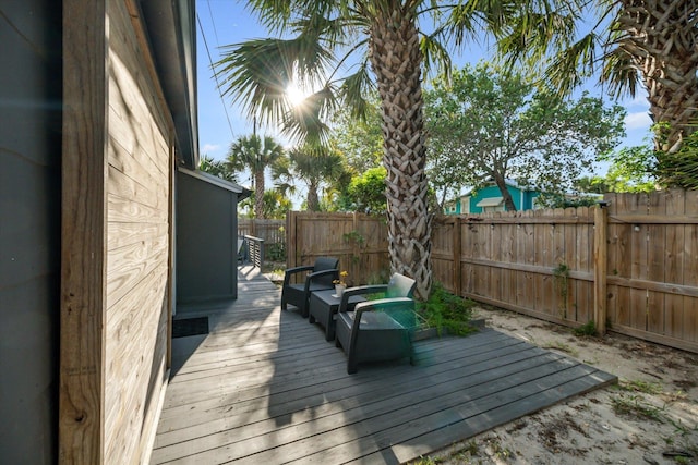 wooden terrace with a fenced backyard