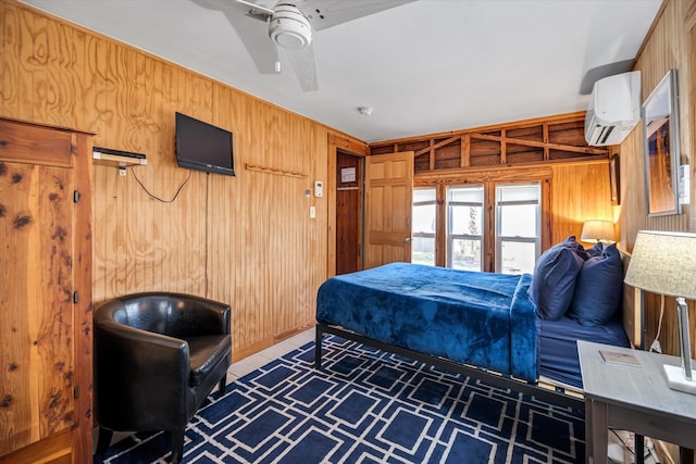 bedroom with a wall mounted AC, wooden walls, and ceiling fan