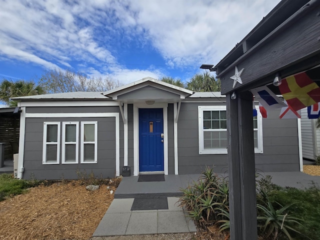 view of exterior entry featuring metal roof