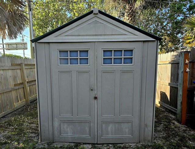 view of shed with a fenced backyard