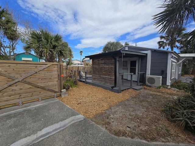 view of home's exterior featuring ac unit and fence