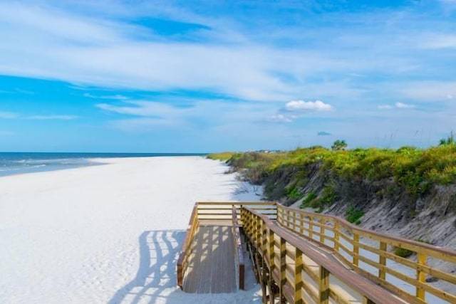 surrounding community featuring a view of the beach and a water view