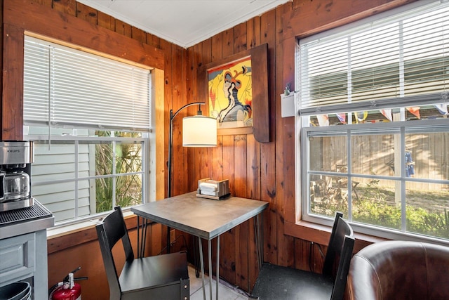 home office with crown molding and wooden walls