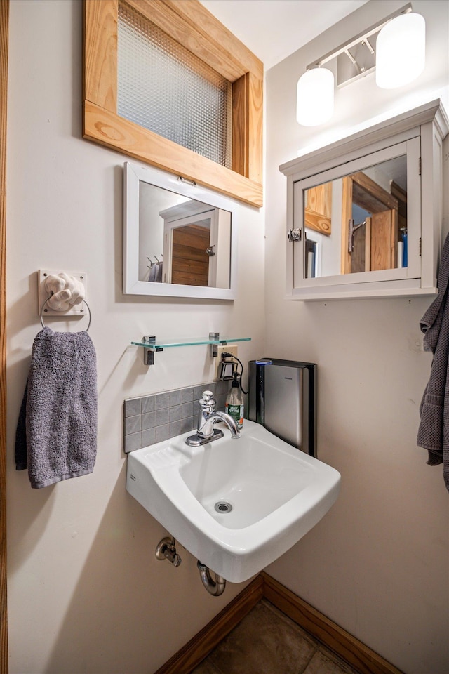 bathroom featuring a sink and baseboards