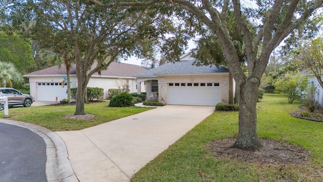 ranch-style house with a garage, a front yard, and driveway