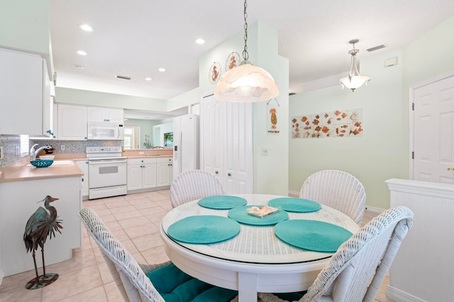 dining space featuring recessed lighting, visible vents, baseboards, and light tile patterned flooring