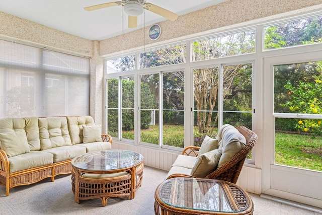 sunroom / solarium featuring a ceiling fan