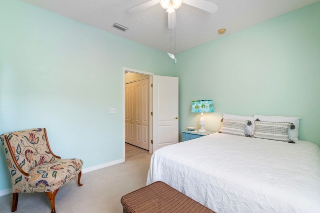 bedroom featuring baseboards, visible vents, ceiling fan, a textured ceiling, and carpet flooring