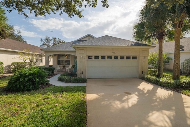 ranch-style home featuring a shingled roof, driveway, an attached garage, and stucco siding