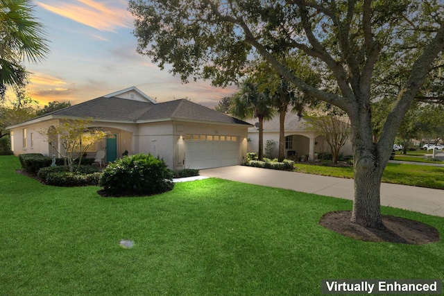 view of front facade with a garage, a front yard, concrete driveway, and stucco siding