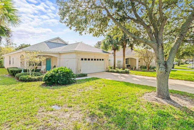 view of front of property featuring a garage, concrete driveway, roof with shingles, a front yard, and stucco siding