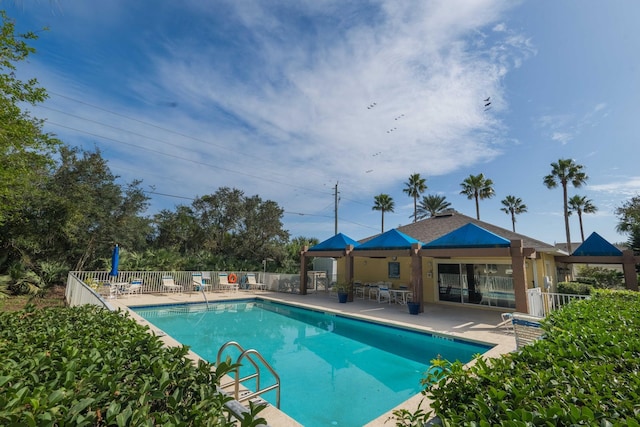 pool featuring a patio area and fence