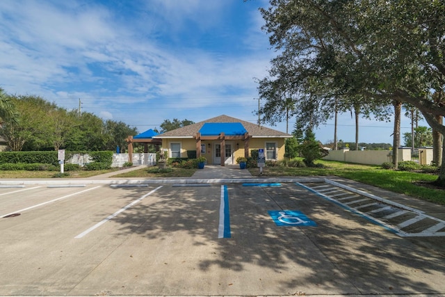 exterior space with uncovered parking and fence