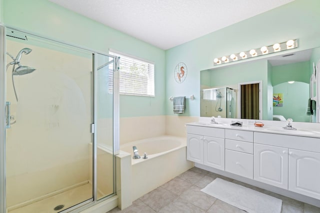 full bath featuring a stall shower, double vanity, a sink, and a bath