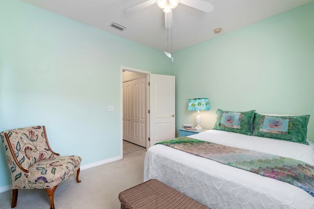 bedroom with baseboards, visible vents, a ceiling fan, a textured ceiling, and carpet floors