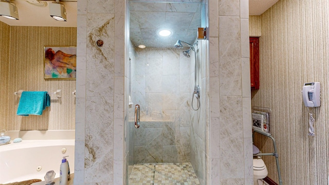 full bathroom featuring a whirlpool tub, wallpapered walls, and a stall shower