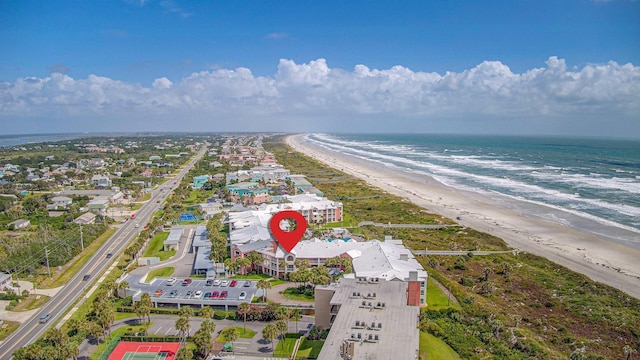 birds eye view of property featuring a water view and a beach view