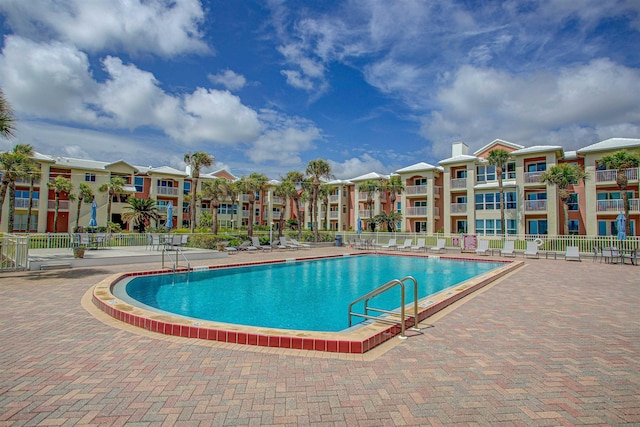 pool featuring a patio area and fence