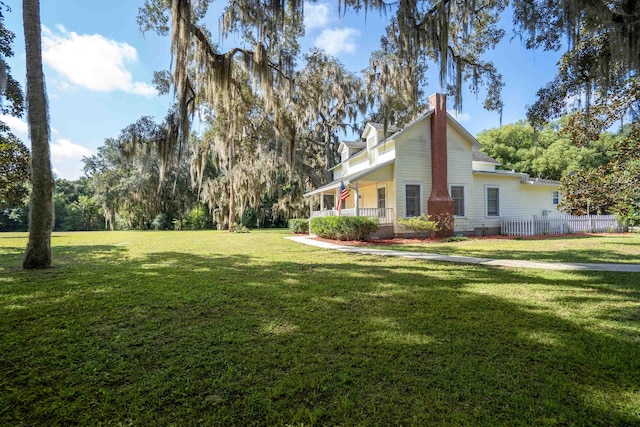 view of yard featuring covered porch