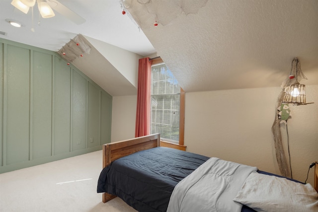 carpeted bedroom featuring ceiling fan and lofted ceiling