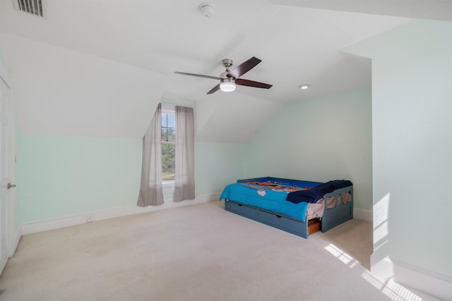 bedroom with light carpet, vaulted ceiling, and ceiling fan