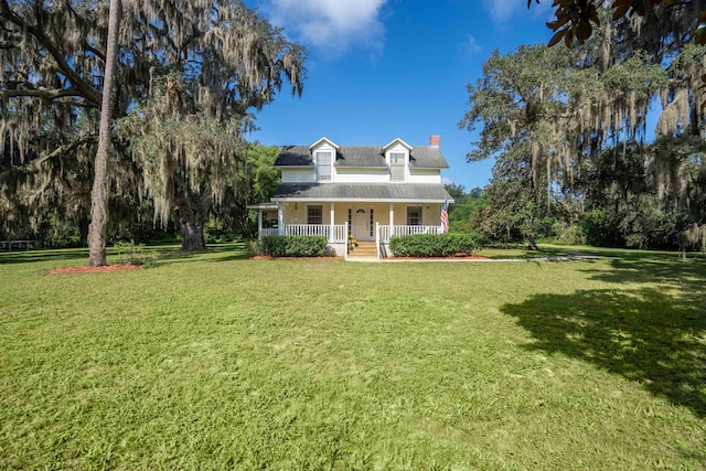 cape cod-style house featuring a porch and a front yard