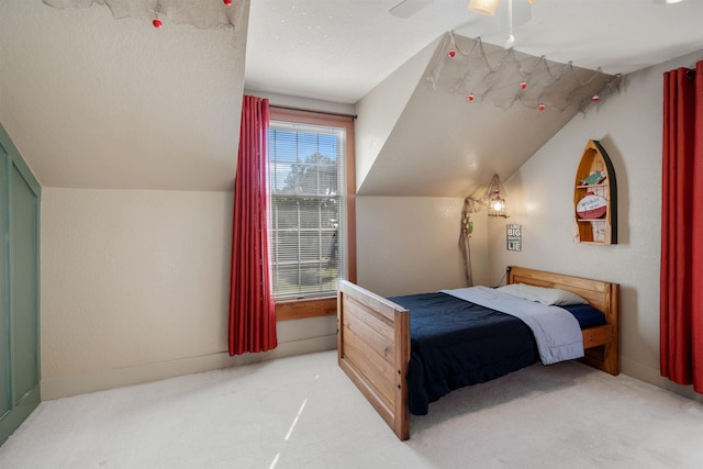 bedroom featuring carpet flooring, ceiling fan, and vaulted ceiling