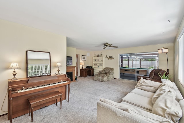1300 Francis St, Saint Augustine, FL 32084 - living room featuring a fireplace, ceiling fan, and carpet floors