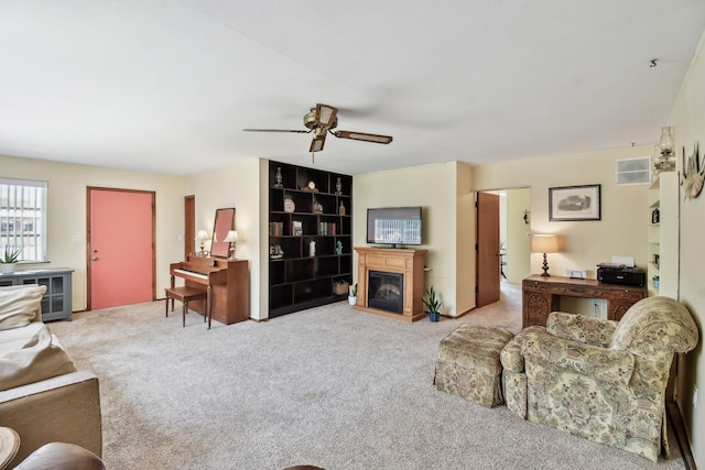 1300 Francis St, Saint Augustine, FL 32084 - living area featuring carpet flooring, a ceiling fan, and a glass covered fireplace