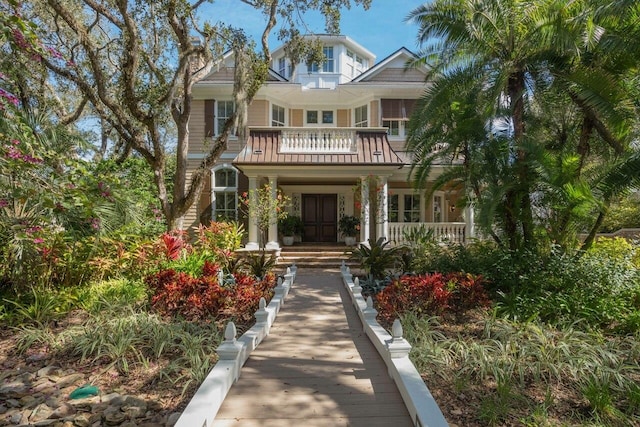 view of front of property with covered porch and a balcony