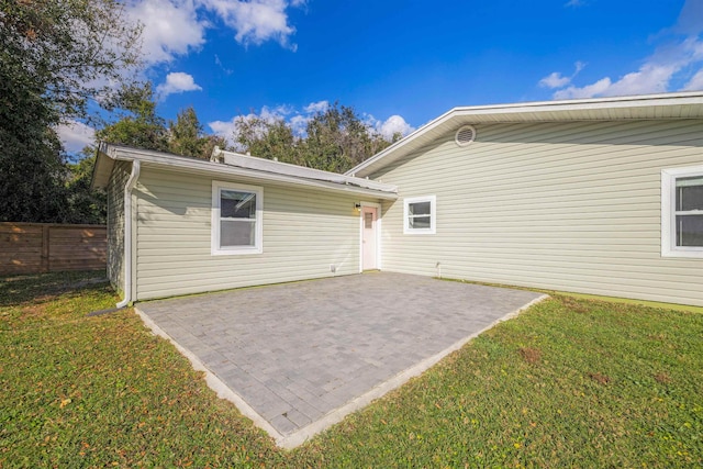 back of house featuring a yard and a patio