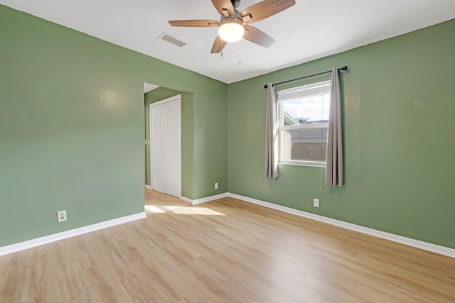 unfurnished room with ceiling fan and light wood-type flooring