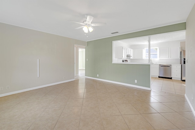 empty room with sink, ornamental molding, ceiling fan, and light tile patterned flooring