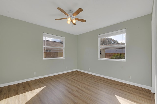 empty room featuring ceiling fan and light hardwood / wood-style flooring