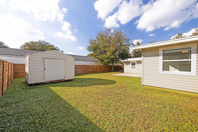 view of yard featuring a storage unit and a patio area