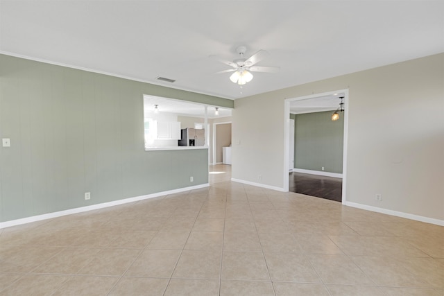 tiled empty room featuring ceiling fan