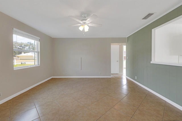 tiled empty room featuring ceiling fan