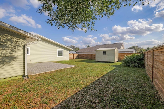 view of yard featuring a patio area and a shed