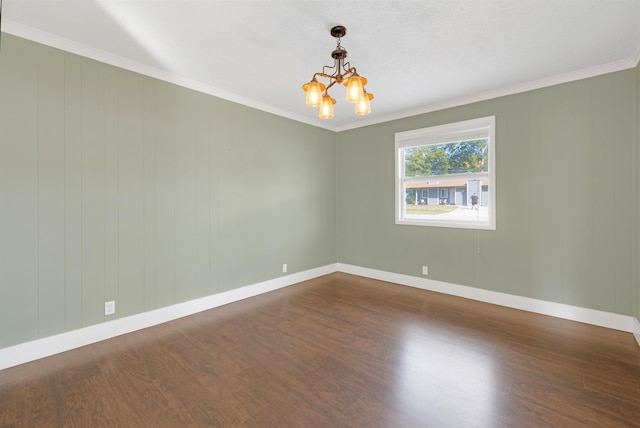 unfurnished room featuring ornamental molding, hardwood / wood-style floors, and a notable chandelier