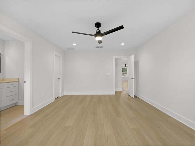 unfurnished bedroom with ceiling fan and light wood-type flooring