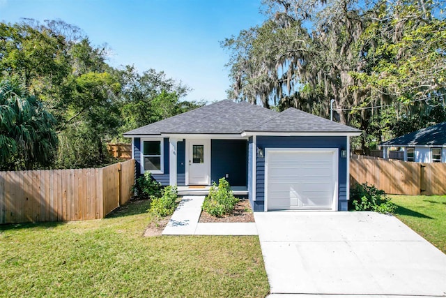 view of front of home featuring a garage and a front lawn