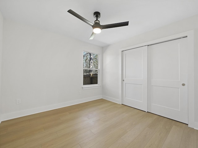 unfurnished bedroom with ceiling fan, a closet, and light hardwood / wood-style flooring